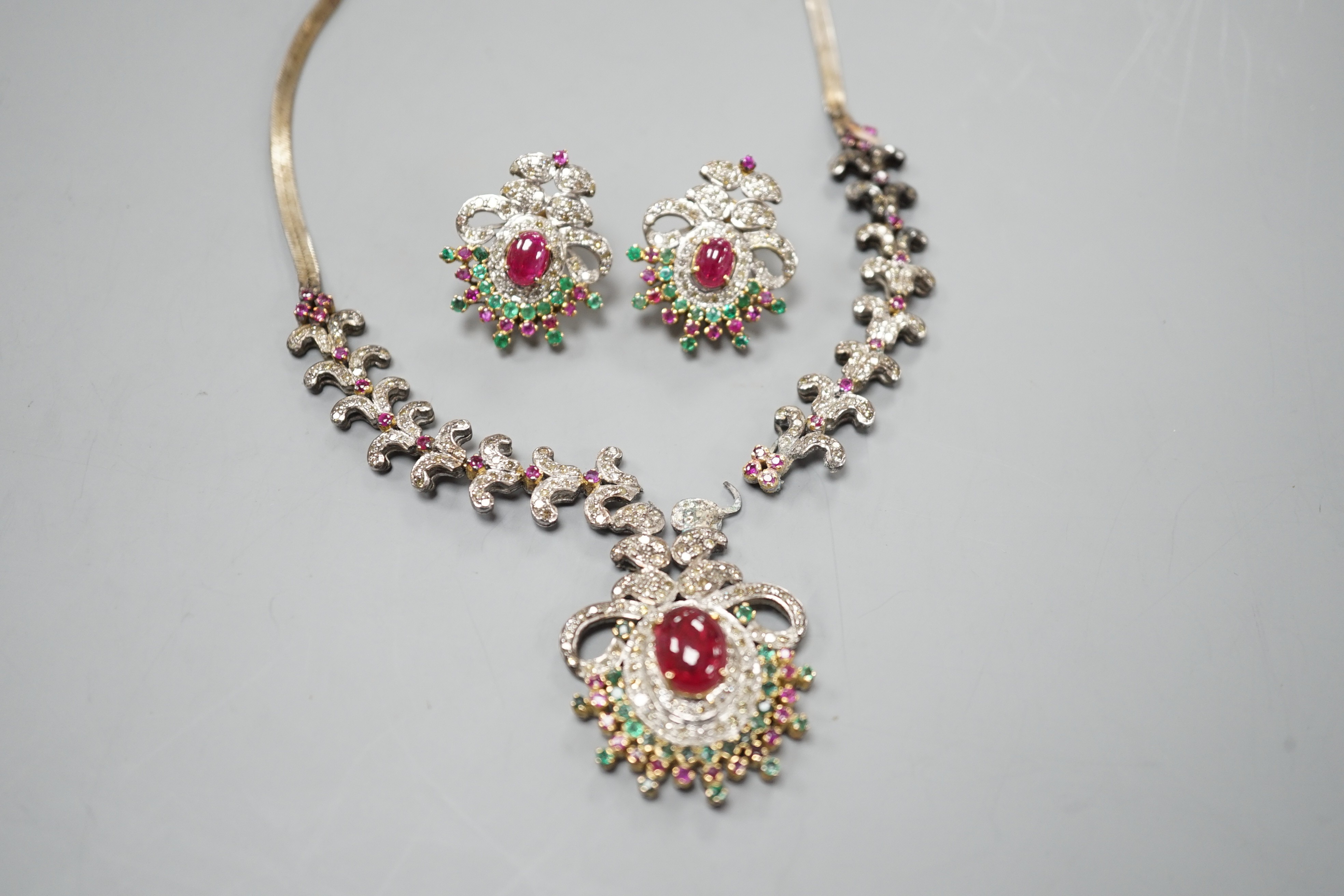 An Indian white and yellow metal, diamond, ruby and gem set necklace, 46cm and pair of matching earrings.